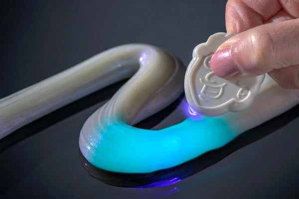 ...or use the included UV charging light to make the putty glow.