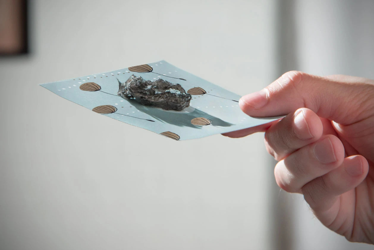 You may choose to catch the burnt wish paper with the paper platform. However, this isn't necessary from a safety standpoint. The ash is cool to the touch.