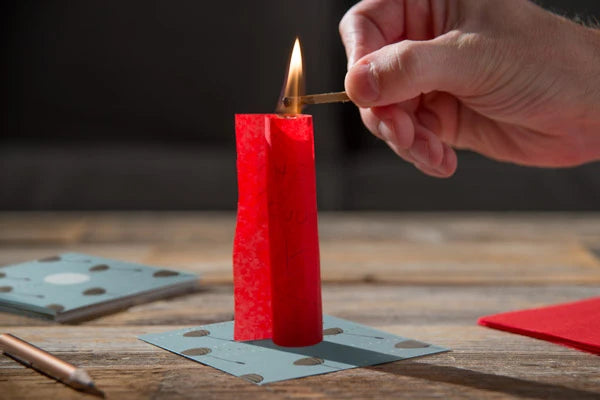 Next, roll the wish paper into a tube and use a match to light it on fire.