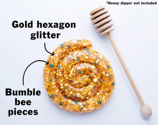 Honey Hive Thinking Putty features an amber base with gold hexagon glitter and bumble bee charms.