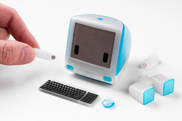 The iconic circular mouse and keyboard replicas accompany the monitor. You can even open the monitor's side panel to reveal an ethernet port!
