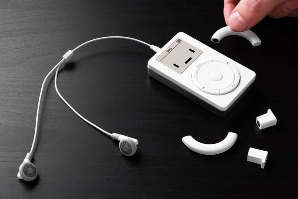 Plug the headphones into the jack at the top to transform the tiny magnetic headphones from wireless to an old school wired set.