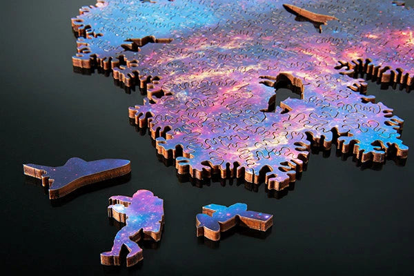 The puzzle is made from laser-cut wood and features three special pieces (satellite, solar array, and astronaut).