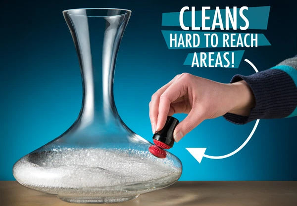 Woman using the Magnetic Spot Scrubber to clean a wine decanter.