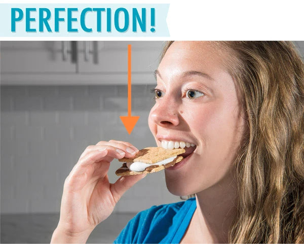 Woman biting into s'more made with the Microwave S'Mores Maker.