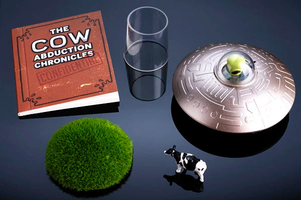 Includes miniature spaceship, cow, faux grass mound, clear display stand, 32-page illustrated booklet, and three 1.5-volt LR44 button cell batteries.