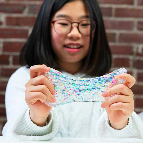 Beautiful, multi-colored sparkles are suspended in the clear putty.