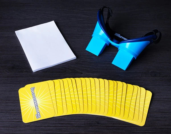 Includes 1 pair of vision-flipping goggles, 1 drawing pad, 25 challenge cards, and 5 create-your-own challenge cards.
