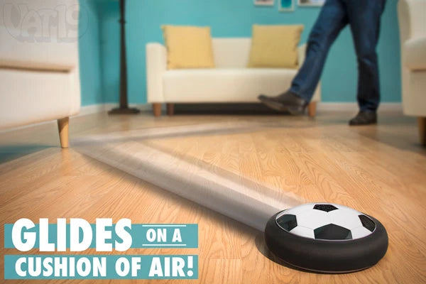 The Air Power Soccer Disc being kicked around a living room.