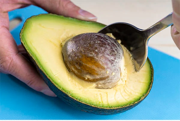 Start by removing the seed from your avocado.