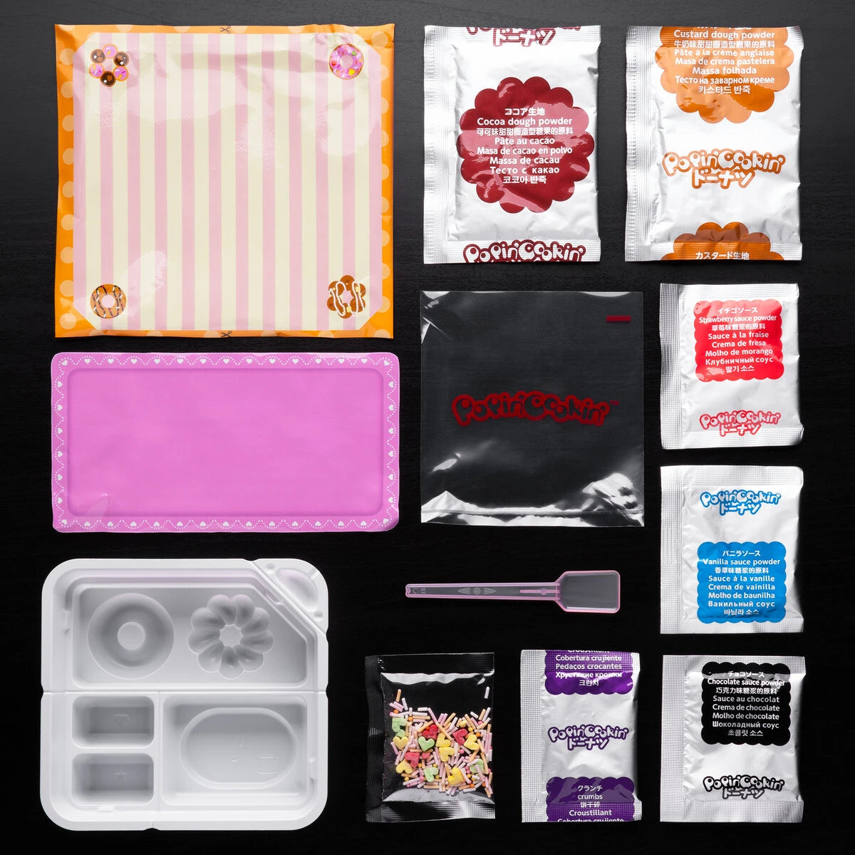 Includes mixing tray, spoon, squeezing bag, sugar sprinkles, and 6 ingredients packets.