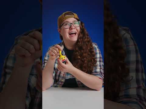 Sloane demonstrates the Mini Baby Shark Otamatone.