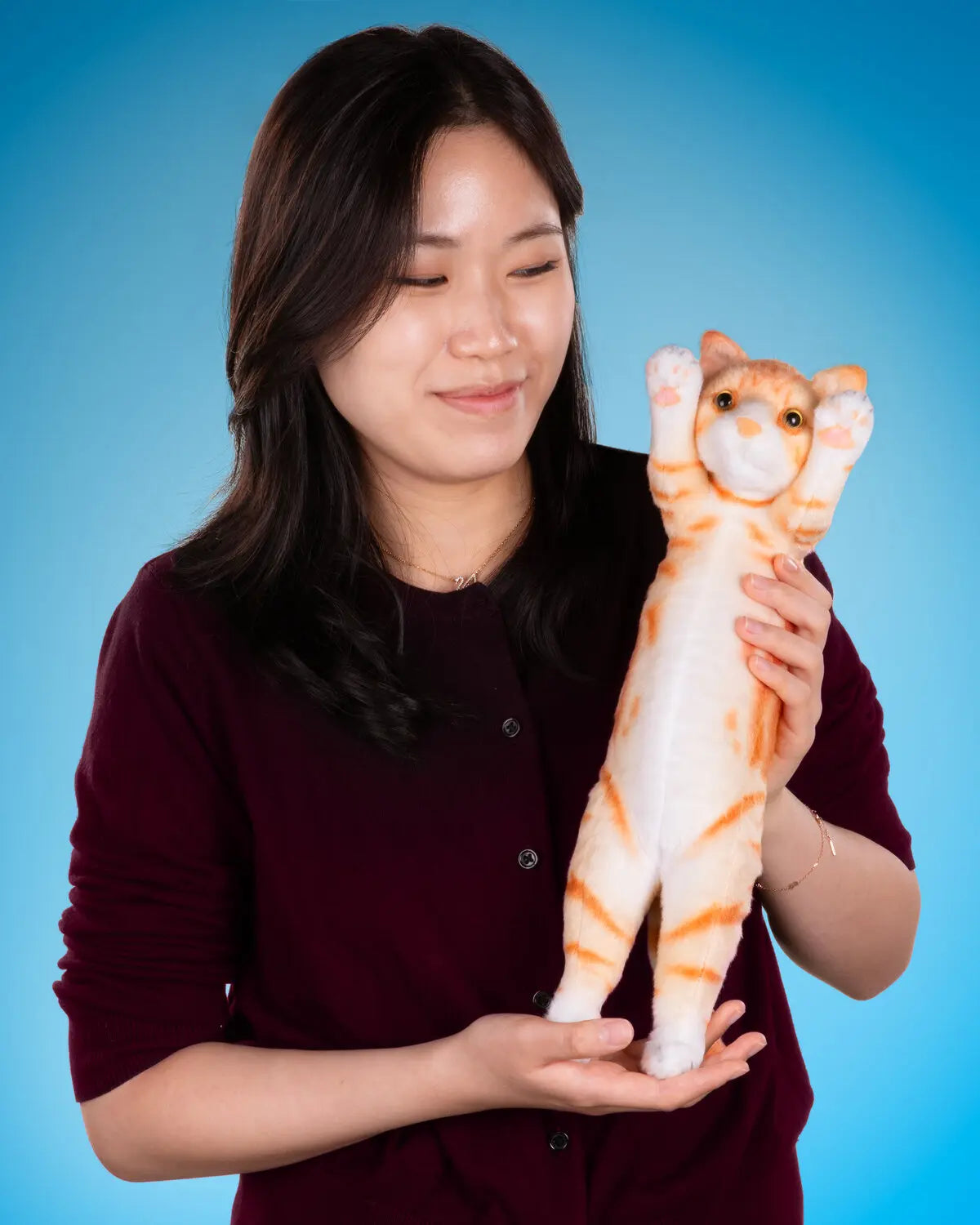 You don't need to hold 'em. These plush cats can stand on their own. 